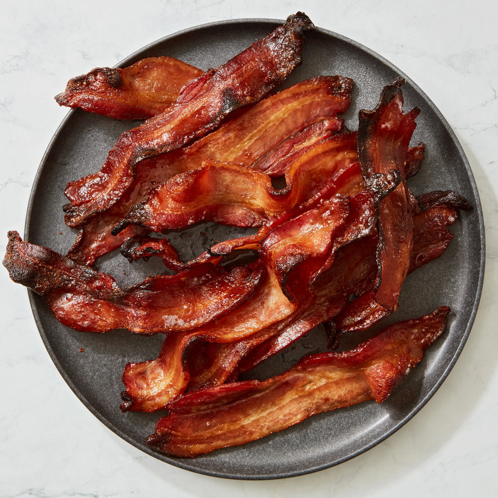a plate of bacon on a marble table